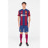 Man wearing Lamine Yamal Barcelona jersey with blue and red stripes, paired with matching shorts and socks